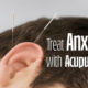Image of acupuncture in an ear with title